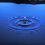 single drop of water hitting a pool of water